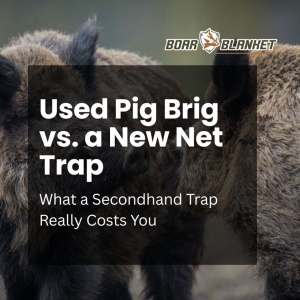 Hero image for a blog post about pig traps: two boars with a dark overlay and the title 'Used Pig Brig vs. a New Net Trap' with the subtitle 'What a Secondhand Trap Really Costs You' and a Boar Blanket logo.
